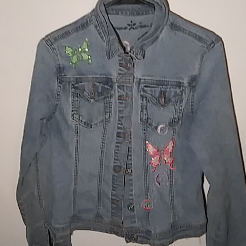 A jean jacket with butterflies